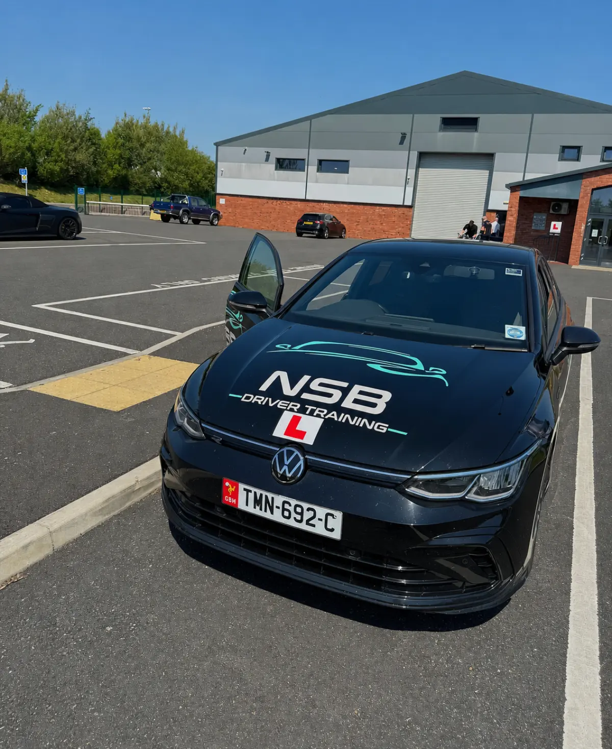 Branded NSB Driver Training Volkswagen in a test-centre car park